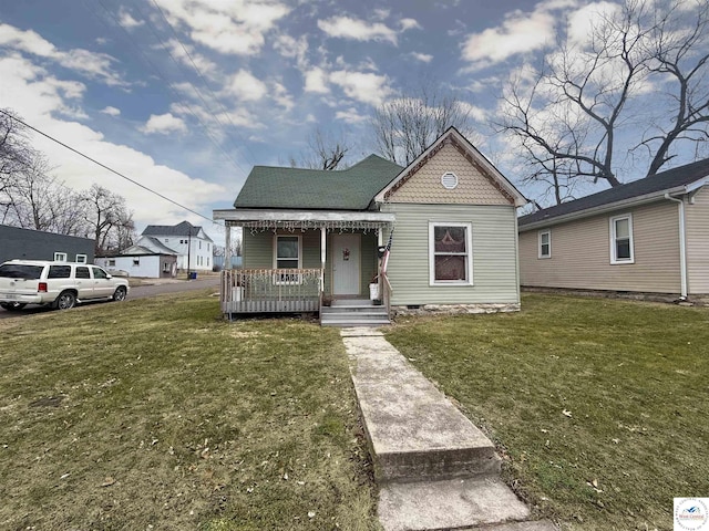 bungalow featuring a porch and a front yard