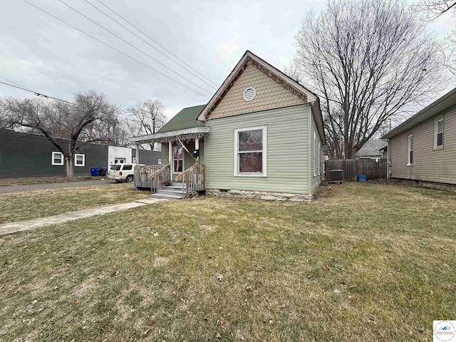 bungalow with fence, cooling unit, crawl space, and a front lawn