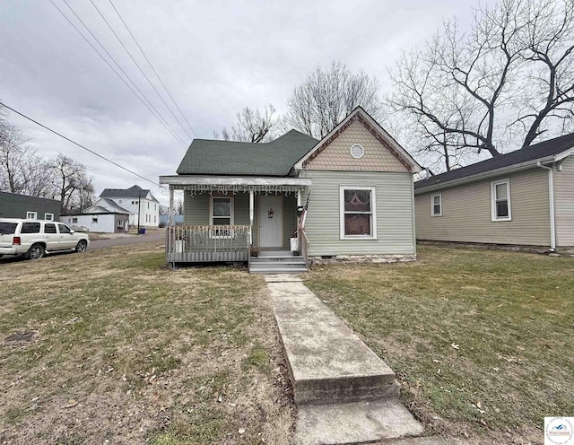 bungalow-style home with a porch and a front lawn