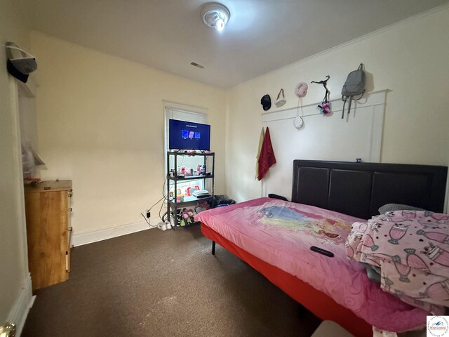 bedroom with visible vents, carpet flooring, and baseboards