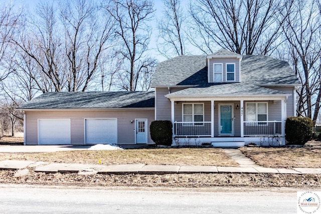 view of front of house with driveway, a porch, and a garage