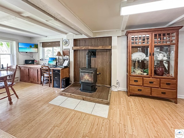 15157 Bass Rd, Gravois Mills, MO 65037 - living room featuring light wood finished floors, a wood stove, plenty of natural light, and baseboards