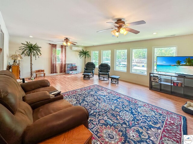 15157 Bass Rd, Gravois Mills, MO 65037 - living area featuring ceiling fan, a wall mounted air conditioner, wood finished floors, and recessed lighting