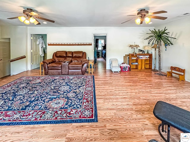 15157 Bass Rd, Gravois Mills, MO 65037 - living area featuring ceiling fan, wood finished floors, and baseboards
