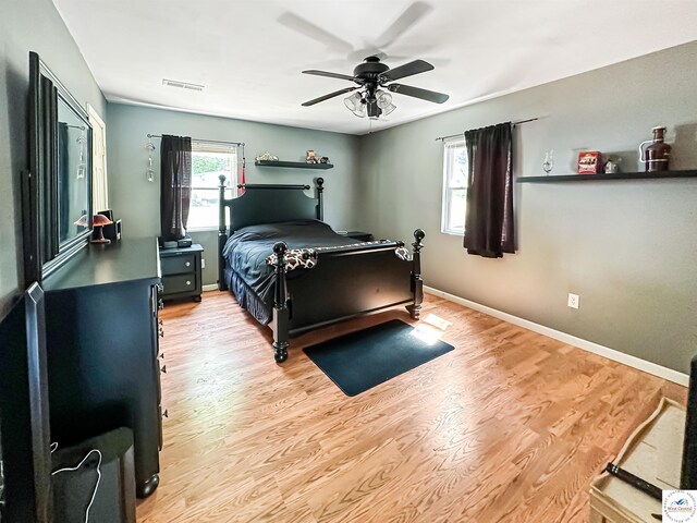 15157 Bass Rd, Gravois Mills, MO 65037 - bedroom featuring wood finished floors, ceiling fan, and baseboards