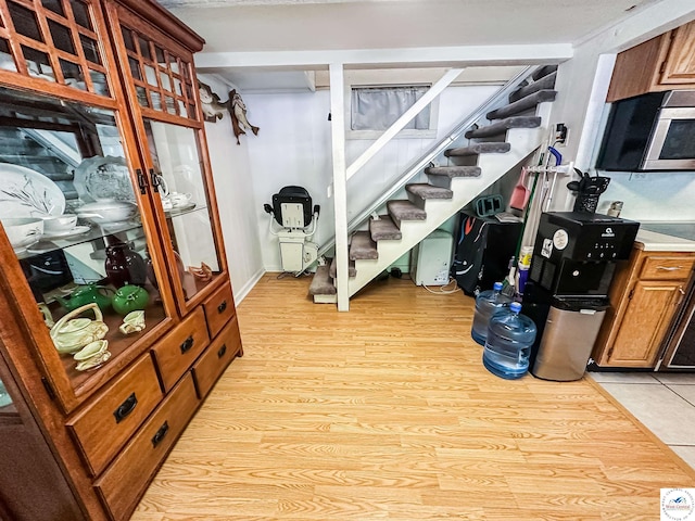15157 Bass Rd, Gravois Mills, MO 65037 - basement featuring stairs and light wood-style flooring