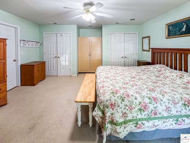 15157 Bass Rd, Gravois Mills, MO 65037 - bedroom featuring multiple closets, light colored carpet, and a ceiling fan
