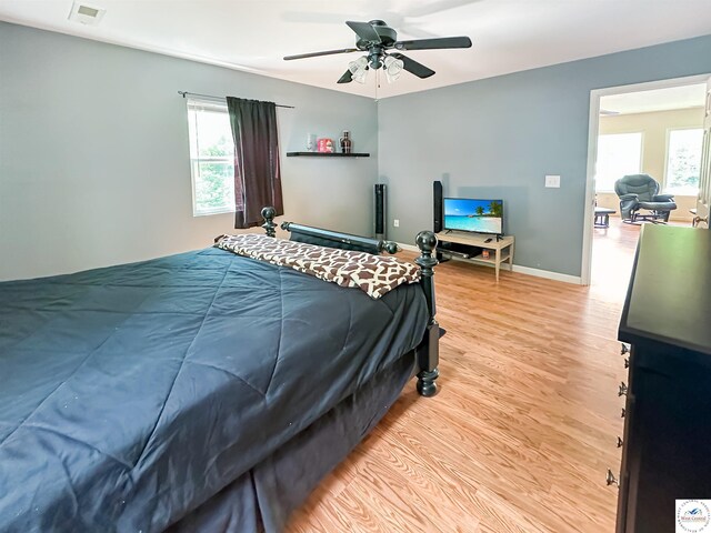 15157 Bass Rd, Gravois Mills, MO 65037 - bedroom with light wood-style floors, baseboards, and a ceiling fan