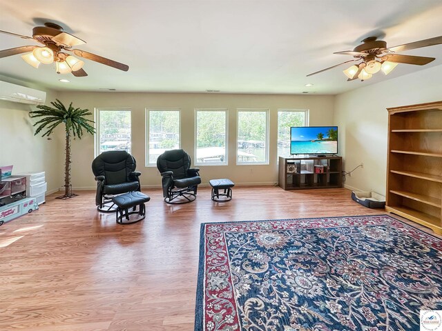 15157 Bass Rd, Gravois Mills, MO 65037 - living room featuring a ceiling fan, healthy amount of natural light, a wall mounted air conditioner, wood finished floors, and recessed lighting
