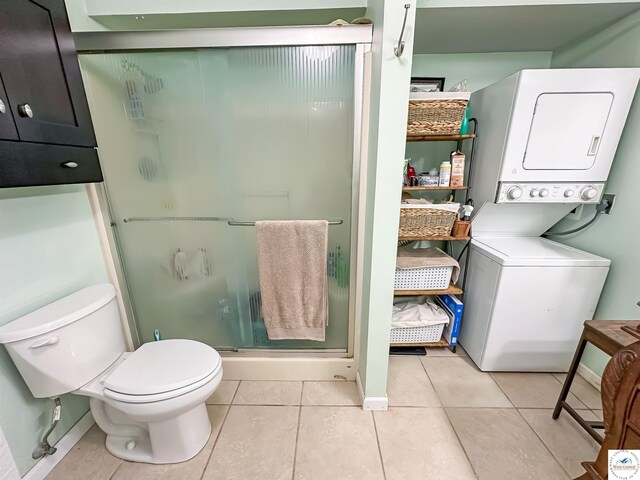 15157 Bass Rd, Gravois Mills, MO 65037 - bathroom featuring estacked washer and dryer, a shower stall, toilet, tile patterned flooring, and baseboards