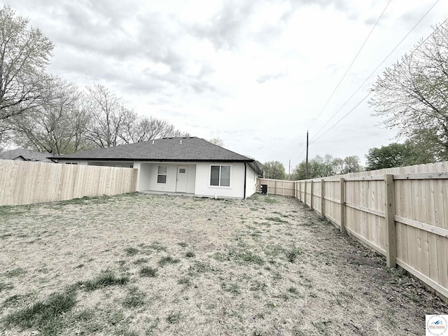 back of property with a fenced backyard