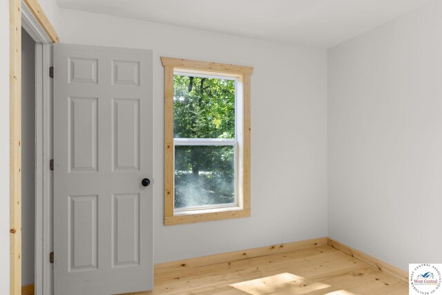 Gardiner Rd, Edwards, MO 65326 - empty room featuring wood finished floors and baseboards