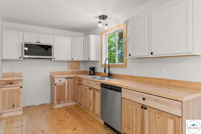 Gardiner Rd, Edwards, MO 65326 - kitchen featuring stainless steel appliances, a sink, light wood-style floors, butcher block countertops, and white cabinets