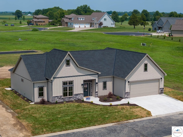 109 Ne 2195 Private Road, Clinton, MO 64735 - view of front of home featuring a front yard, driveway, stone siding, and a garage