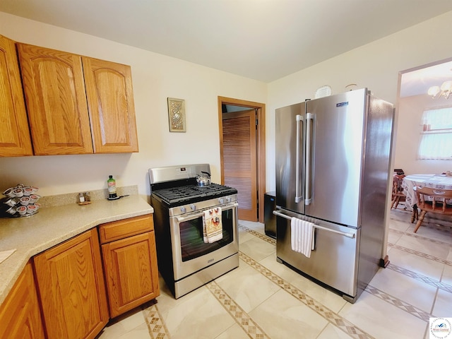 330 W State St, Tipton, MO 65081 - kitchen with light tile patterned floors, an inviting chandelier, appliances with stainless steel finishes, and light countertops