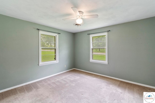 1209 E Franklin St, Clinton, MO 64735 - empty room featuring healthy amount of natural light, carpet, and a ceiling fan