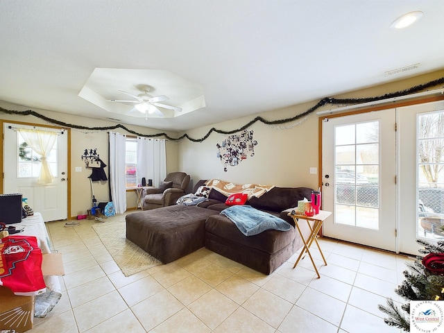 113 SE 1171st Rd, Knob Noster, MO 65336 - living room with light tile patterned flooring, a ceiling fan, and a tray ceiling