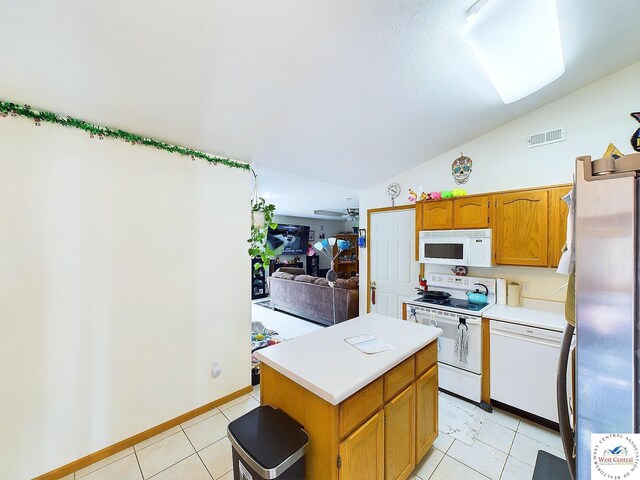 113 SE 1171st Rd, Knob Noster, MO 65336 - kitchen with white appliances, lofted ceiling, light countertops, light tile patterned flooring, and a kitchen island