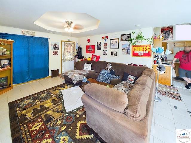 113 SE 1171st Rd, Knob Noster, MO 65336 - living room featuring tile patterned flooring, a ceiling fan, and a tray ceiling