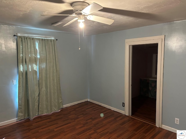 923 E Walnut St, Rich Hill, MO 64779 - unfurnished bedroom with ceiling fan, wood finished floors, and baseboards