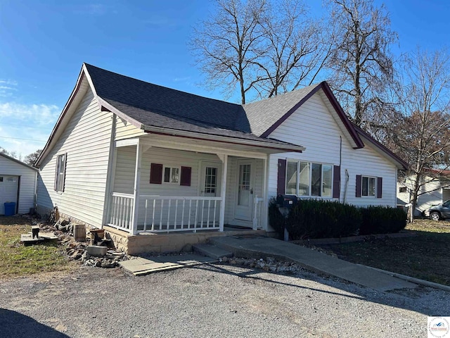 923 E Walnut St, Rich Hill, MO 64779 - bungalow-style house with a porch and a shingled roof