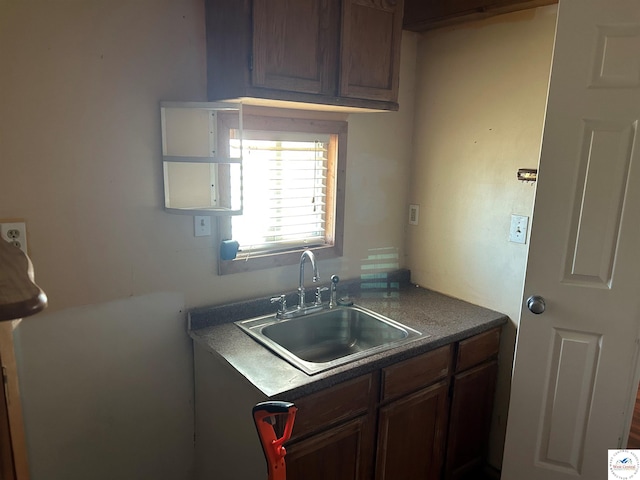 923 E Walnut St, Rich Hill, MO 64779 - kitchen with dark countertops and a sink