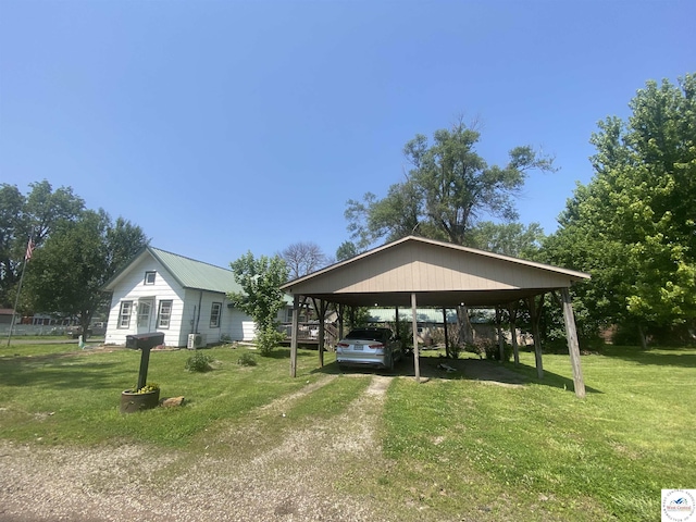 208 S Dixon, Lowry City, MO 64763 - view of community featuring a carport, dirt driveway, and a yard