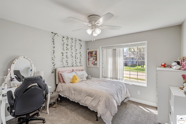 carpeted bedroom with a ceiling fan and baseboards