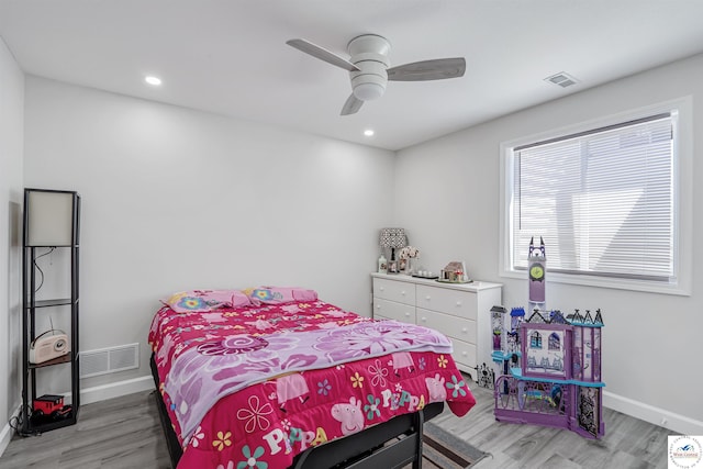 bedroom featuring baseboards, visible vents, and wood finished floors