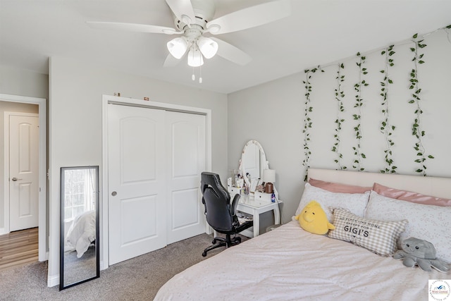 carpeted bedroom featuring a ceiling fan and a closet