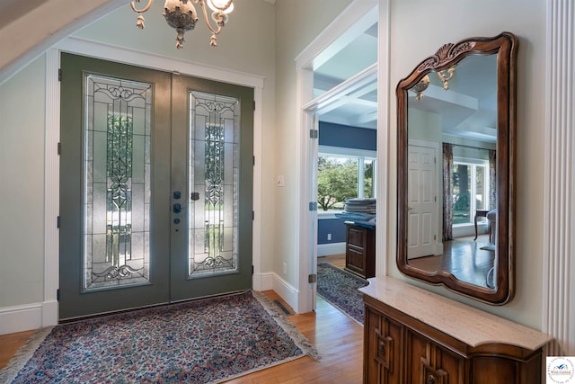 1114 W Broadway Blvd, Sedalia, MO 65301 - foyer featuring a chandelier, light wood-style flooring, and french doors