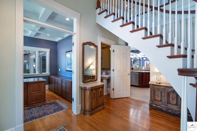 1114 W Broadway Blvd, Sedalia, MO 65301 - stairs featuring wood finished floors, a chandelier, beam ceiling, coffered ceiling, and recessed lighting