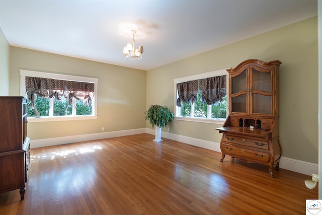1114 W Broadway Blvd, Sedalia, MO 65301 - spare room with a chandelier and wood finished floors