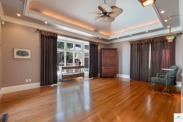 1114 W Broadway Blvd, Sedalia, MO 65301 - living room featuring a tray ceiling, light wood finished floors, crown molding, ceiling fan, and recessed lighting