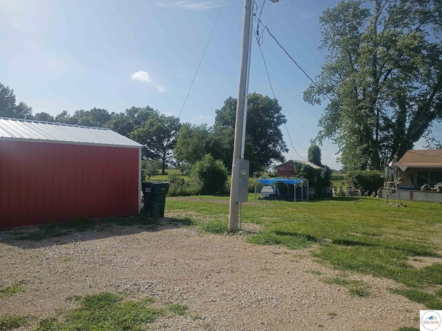 30512 S Hess Rd, Harrisonville, MO 64701 - view of green lawn with an outdoor structure and a pole building