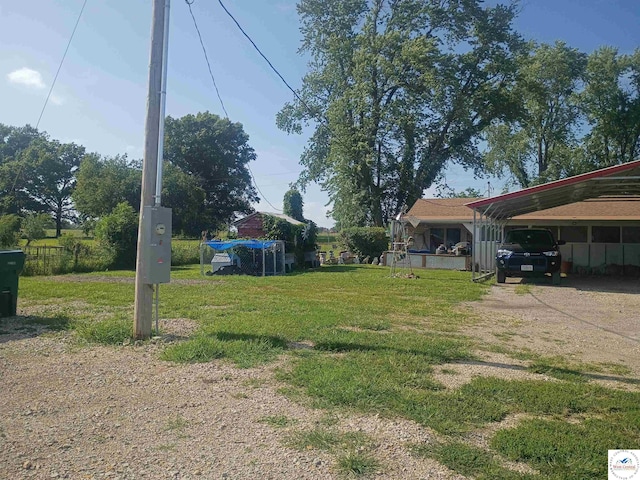 30512 S Hess Rd, Harrisonville, MO 64701 - view of green lawn with driveway and a detached carport