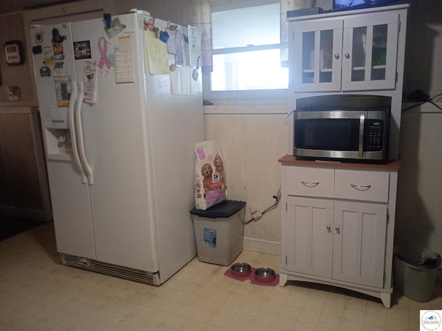 30512 S Hess Rd, Harrisonville, MO 64701 - kitchen with white refrigerator with ice dispenser, stainless steel microwave, and white cabinets