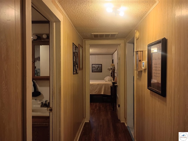 30512 S Hess Rd, Harrisonville, MO 64701 - hall featuring a textured ceiling, dark wood-style floors, and ornamental molding
