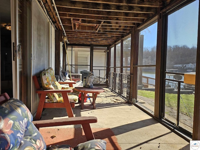 sunroom / solarium with a water view and a wealth of natural light