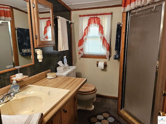 bathroom featuring vanity, toilet, a stall shower, crown molding, and visible vents