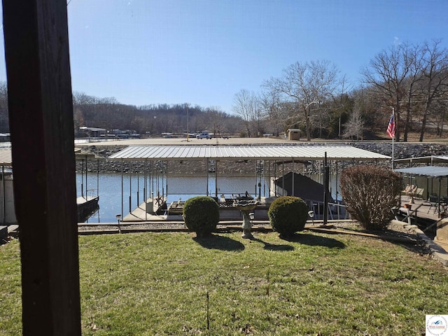 dock area featuring a lawn, a water view, and boat lift