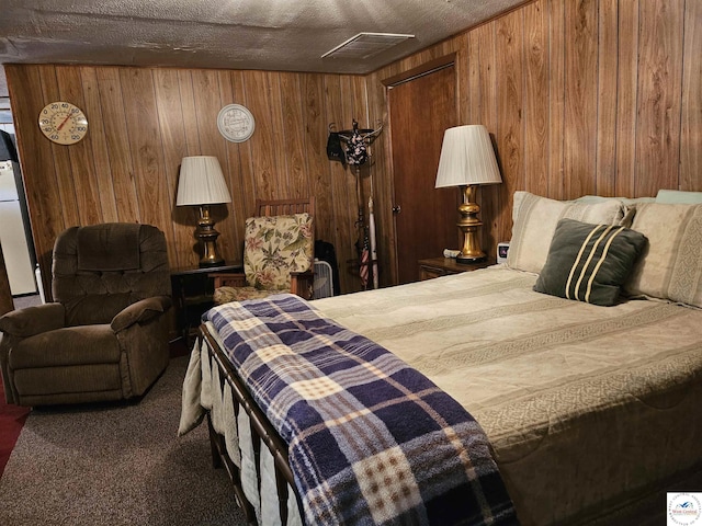 bedroom featuring wood walls, visible vents, and carpet floors