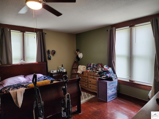 bedroom featuring a ceiling fan, a textured ceiling, and wood finished floors