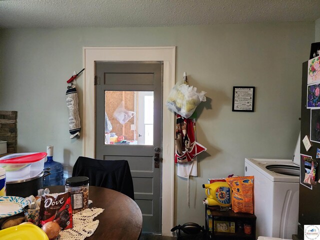 dining area with a textured ceiling and washing machine and clothes dryer
