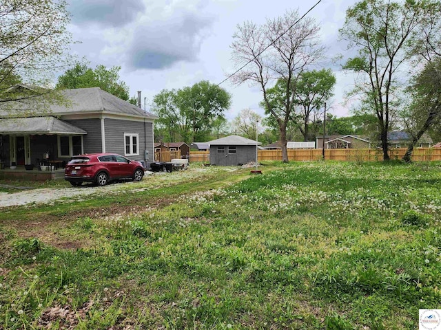 view of yard with an outdoor structure and fence
