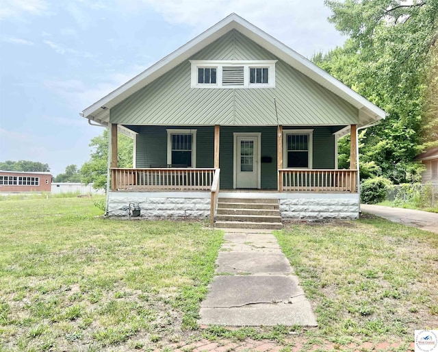 bungalow with a porch and a front lawn