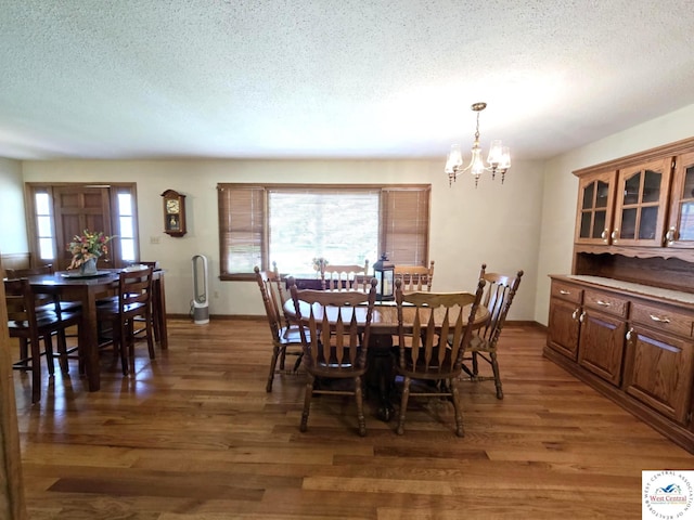 502 S Ferguson Ave, Tipton, MO 65081 - dining room with an inviting chandelier, light wood-type flooring, a textured ceiling, and a healthy amount of sunlight