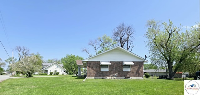 502 S Ferguson Ave, Tipton, MO 65081 - view of side of property with brick siding and a lawn