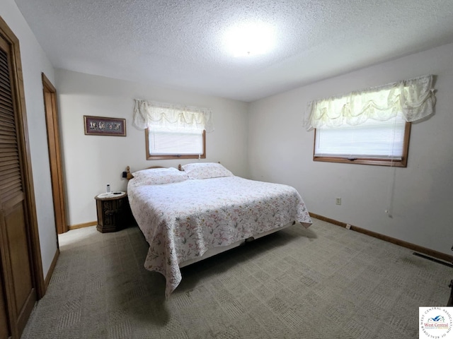 502 S Ferguson Ave, Tipton, MO 65081 - bedroom featuring a textured ceiling, multiple windows, and baseboards