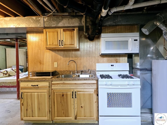 502 S Ferguson Ave, Tipton, MO 65081 - kitchen featuring light brown cabinetry, wood walls, a sink, water heater, and white appliances